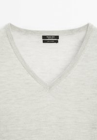 Light gray V-neck cashmere sweater with massimo dutti brand label sewn inside collar.