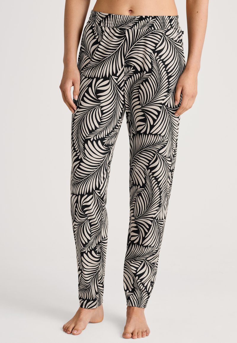 Zwarte en crèmekleurige geprinte broek met een palmbladontwerp. Elastische tailleband en taps toelopende boorden. Lichtgewicht stof met een gladde textuur.
