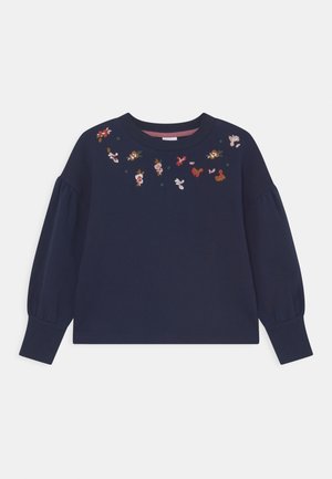 Marineblå langærmet skjorte med puffede ærmer og små flerfarvede blomsterbroderier langs udskæringen.