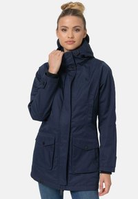 Navy blue waterproof parka jacket with a high collar, front zip, snap buttons, two large front pockets, and adjustable hood.