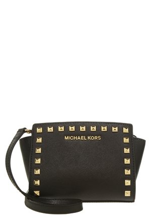 Czarna kopertówka na nadgarstek Michael Kors z złotymi piramidalnymi ćwiekami zdobiącymi przód oraz dopasowanym czarnym paskiem na nadgarstek.