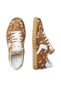 Brown and white spotted sneakers with textured faux fur upper, white laces, and rubber sole, featuring a distinct ridged design.