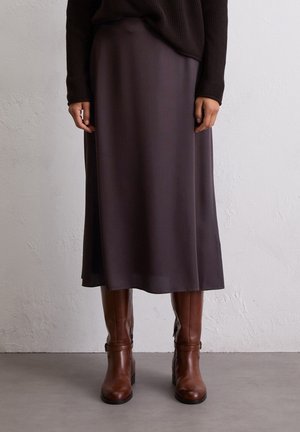 Brown knit sweater paired with a dark brown satin midi skirt, featuring a smooth texture and gentle drape, worn with brown leather knee-high boots.