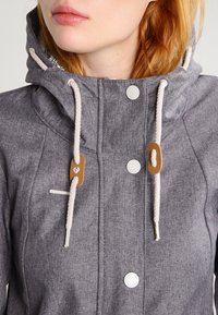 Gray hooded jacket with a textured finish, featuring white drawstrings, brown hardware accents, and metal snap buttons.
