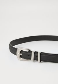 Black leather belt with a silver metal buckle, featuring two prongs and a smooth texture, designed with evenly spaced holes for adjustment.