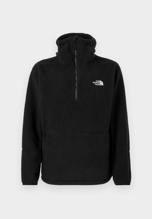 Črn flis pulover z visokim ovratnikom, polno zadrgo spredaj, stranskimi žepi in belim logotipom "The North Face" na levem prsnem delu.