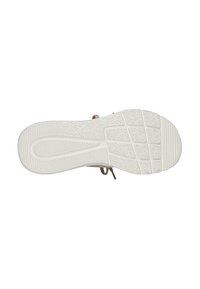 Suola di sneakers in gomma bianca con motivi di grip testurizzati. Presenta dettagli in pizzo marrone sul lato. Sezioni ovali e scanalate per la trazione.