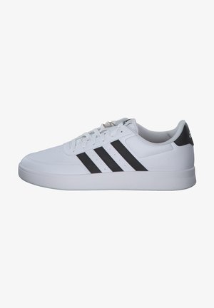 White athletic shoe with synthetic upper, featuring three black stripes and a white rubber sole. Simple lace-up design with padded collar.
