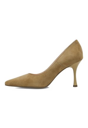 Zapato de tacón alto de ante beige con punta afilada y un tacón metálico delgado. Textura suave con detalles de costura mínimos.