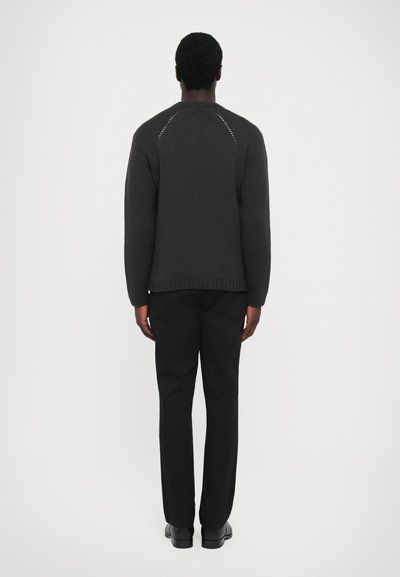 Dark gray knit sweater with a round neckline, ribbed cuffs, and hem; features a textured design and protective stitching at shoulder seams.