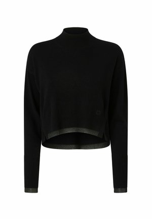 Pull court noir à col haut, texture côtelée et ourlet vert contrastant. Il possède de longues manches et des fentes sur les côtés en bas.