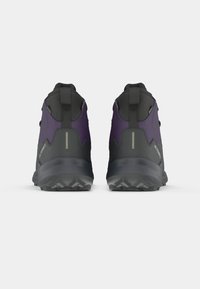 Black and purple hiking shoes with a high ankle design, textured upper, durable sole, and reflective accents on the back.
