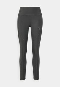 Leggings deportivos negros con una cintura alta, que presentan costuras en contraste y un pequeño logotipo. Textura suave y diseño ajustado.