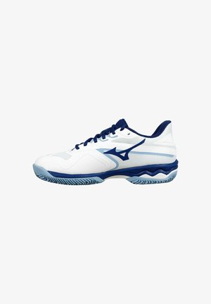 White athletic shoe with navy blue accents, featuring a mesh upper, textured sole, and distinctive wave pattern on the midsole.