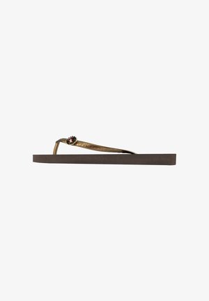 Brown flip-flop with a flat sole, featuring a thin metallic strap adorned with a decorative stone accent. Industrial design, casual style.