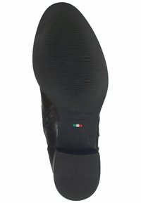 Suola in pelle nera con motivo di grip testurizzato, dotata di branding e dettaglio bandiera. Progettata per durevolezza e trazione.