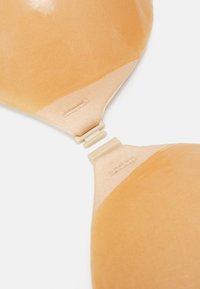 Nude padded bra with smooth, shiny fabric. Features adjustable straps and a plastic clasp. Soft texture with a seamless design.