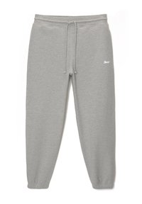 Pantalon de survêtement en coton gris clair avec taille élastique, cordon de serrage, chevilles élastiquées et petit logo blanc sur la partie supérieure de la jambe gauche.