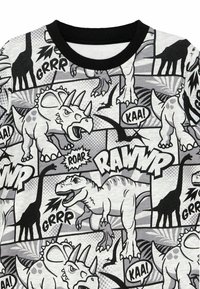 Schwarz-weißes Kurzarmhemd mit einem Comic-Stil Dinosaurierdruck, der verschiedene Muster, Sprechblasen und strukturierte Grafiken zeigt.