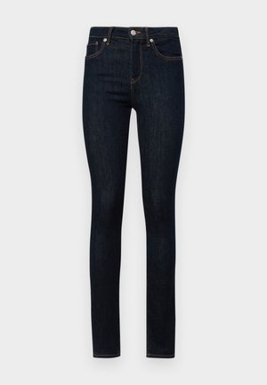 Donkerblauwe denim skinny jeans met een vijf-pocket ontwerp, knoopsluiting en contrasterende oranje stiksels. Gladde textuur en vormgevende pasvorm.