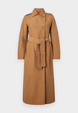 Double-breasted trench coat in light brown cotton with a belted waist, shoulder epaulets, and long sleeves. Smooth texture with minimal hardware.