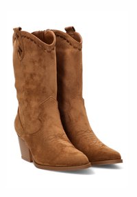 Botas de vaquero de ante marrón con punta afilada, tacón de bloque de altura media, costuras decorativas y detalles con borde ondulado en la parte superior.