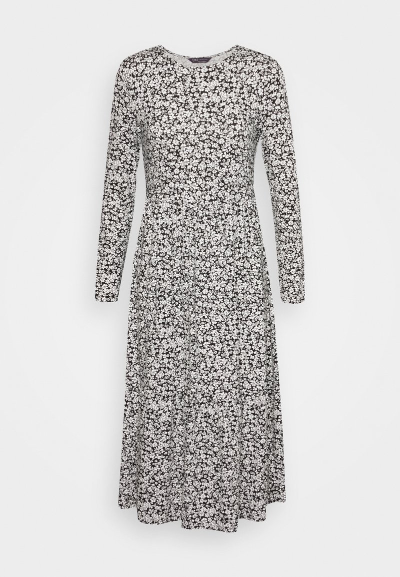 Robe à manches longues noire avec un motif floral blanc, dotée d'un col rond et d'une jupe évasée. Texture de tissu lisse.