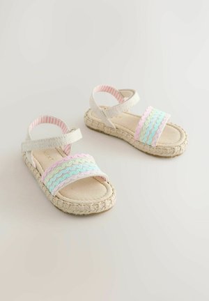Laste beežid sandaalid punutud talladega ning pastelsinist, rohelist ja roosat lainelise kujuga rihmad, millel on pahkluu Velcro kinnitused.