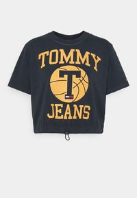 Černé zkrácené tričko vyrobené z bavlny, s žlutou grafikou basketbalového míče a textem "TOMMY JEANS". Elastický lem s detaily na stahování.