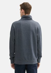 Donkergrijze pullover sweatshirt met een hoge kraag, ribgebreide mouwen en zoom. Gladde textuur met een subtiel heatherpatroon. Eenvoudig ontwerp.