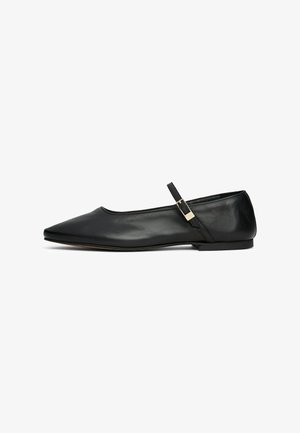 Zapato plano de Mary Jane de cuero negro con punta afilada y tira delgada ajustable con hebilla dorada, mostrado en perfil lateral sobre fondo blanco.