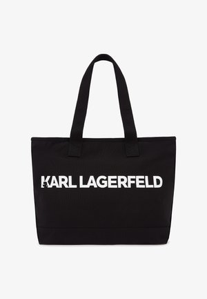 Black tote bag made of durable fabric featuring white "KARL LAGERFELD" logo. Includes two sturdy top handles for easy carrying.