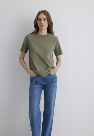 Olive green cotton t-shirt with a round neckline and short sleeves, paired with light blue denim jeans featuring a fitted waist and straight legs.