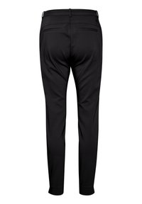 Pantalon habillé noir coupe slim avec passants pour ceinture et deux poches passepoilées à l'arrière, vu de dos sur fond blanc.