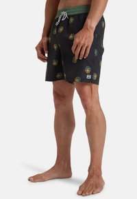 Pantaloni da bagno neri con motivi circolari in verde, arancione e teal, vita elastica con stringa, tasche laterali e piccolo dettaglio del logo.