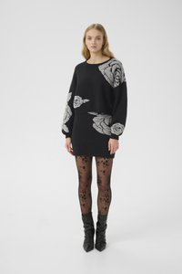 Black sweater dress with floral patterns, soft knit texture, long sleeves, paired with sheer black floral tights and slouchy black boots.