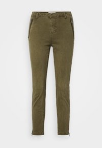 Olive green slim-fit pants with a smooth texture, featuring zippered pockets and ankle zips for adjustable fit. Structured design with knee seams.