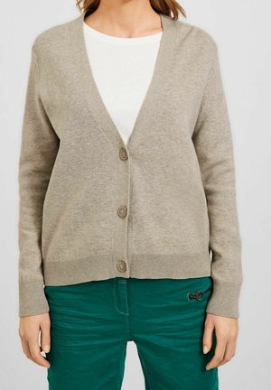 Beige knitted cardigan with a V-neck, five buttons, ribbed cuffs, and hem, paired with green pants featuring a zip pocket.