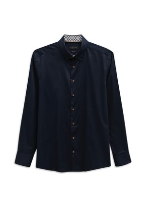 Navy long-sleeve shirt with a button-down collar, featuring brown buttons, smooth texture, and a patterned fabric lining inside the collar.