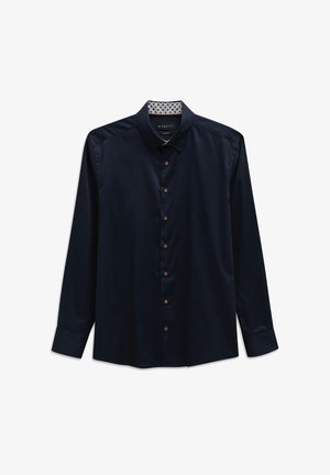 Navy long-sleeve shirt with a button-down collar, featuring brown buttons, smooth texture, and a patterned fabric lining inside the collar.