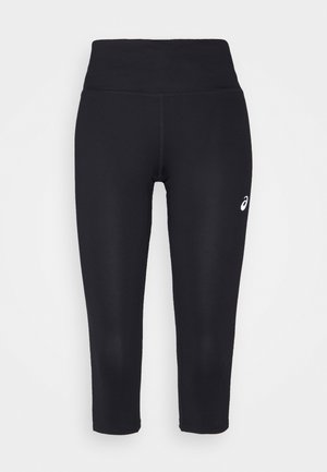 Czarne legginsy do kostek wykonane z elastycznego materiału, z wysokim stanem i małym białym logo na dolnej lewej nodze.