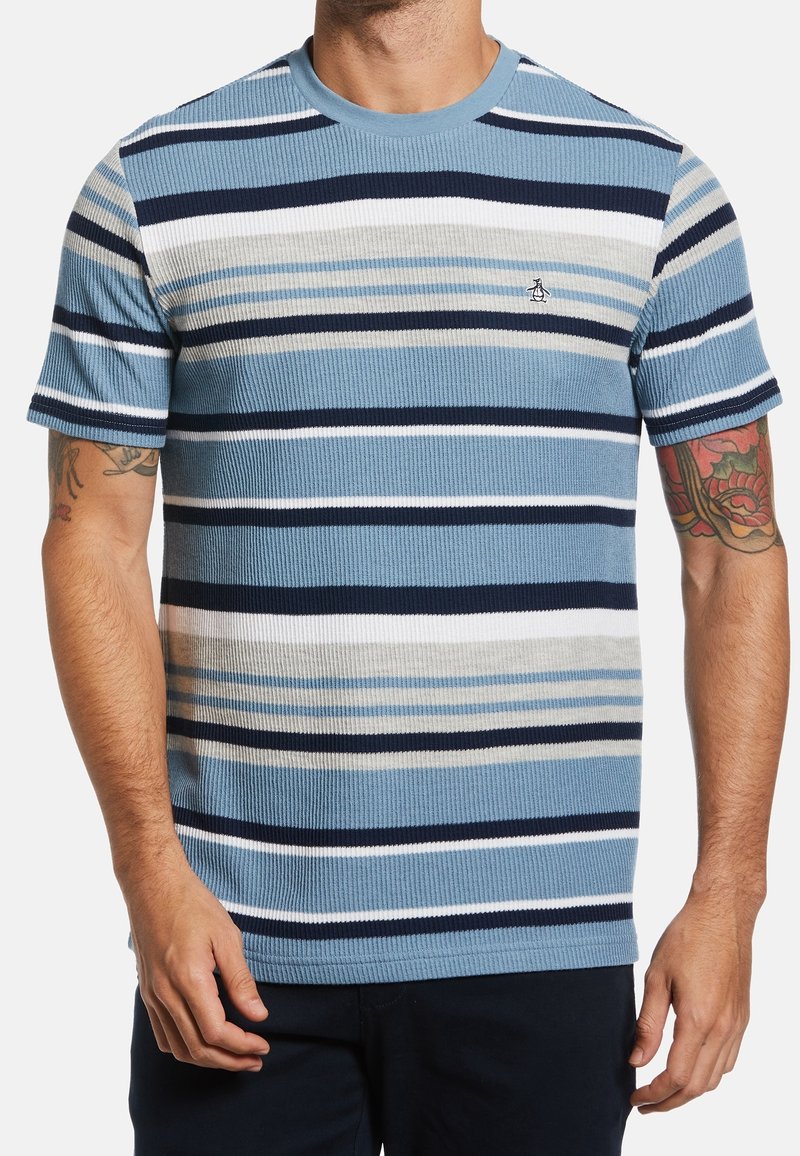 Striped blue t-shirt with varying shades of blue, navy, white, and gray. Ribbed texture, crew neck, and small logo on the chest.