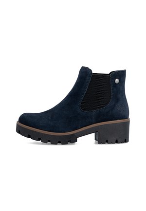 Ankle-high black suede boot with thick lug sole, chunky heel, elastic side panel, and small round metal emblem near the top.