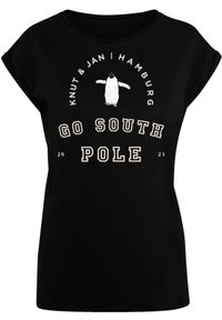 Schwarzes Baumwoll-T-Shirt mit kurzen Ärmeln, das ein Pinguin-Graphic zeigt, den Text "GO SOUTH POLE" und "Knut & Jan | Hamburg 2023" darüber.