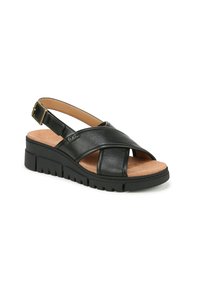 Sandali slingback in pelle nera con cinturini incrociati, soletta in sughero e suola in gomma testurizzata per una maggiore aderenza. Dettaglio fibbia sul cinturino.