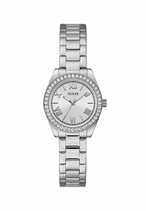 Montre en métal argenté avec un cadran rond et des embellissements en cristal. Le cadran présente des chiffres romains et un bracelet en métal poli.