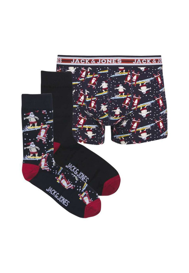 Ensemble de boxers et chaussettes pour hommes avec un motif sombre mettant en scène un Santa surfant, des flocons de neige blancs et des accents rouges contrastants.