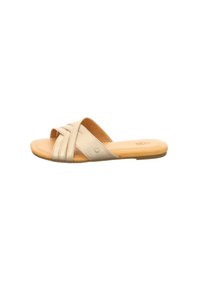 Beige slip-on sandal with crisscross straps and cushioned tan insole, flat sole, minimalist design for casual wear.