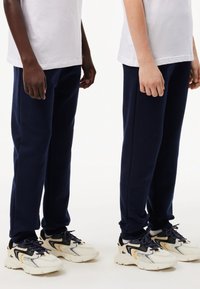 Lacoste CORE PANT UNISEX - Tracksuit bottoms - marine