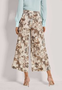 Brede broek met een bloemmotief in beige en bruine tinten, met een elastische tailleband en lichte stof.